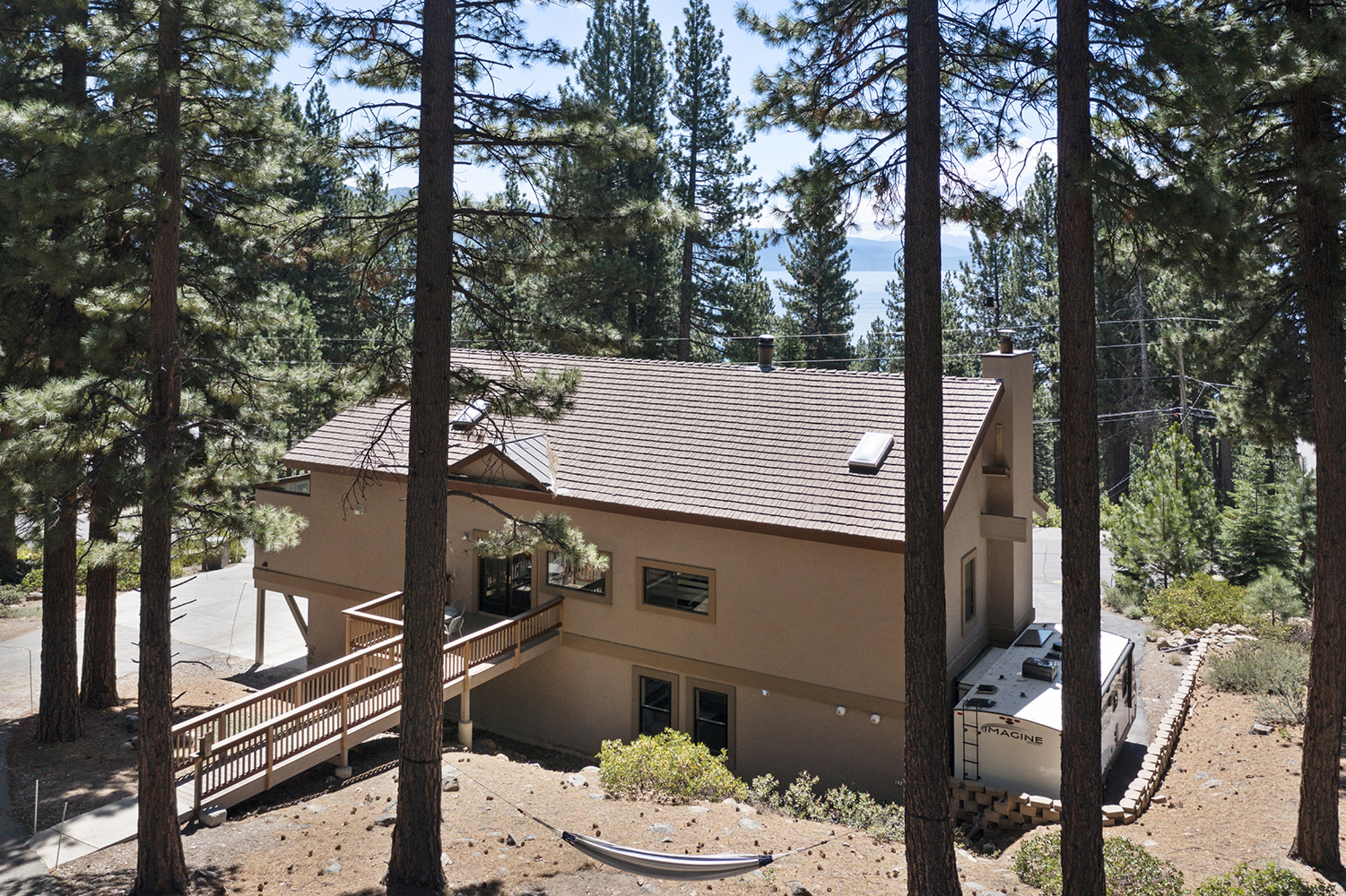 Kinpine House among tall pines on a sunny day